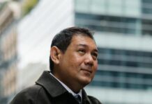 Leadership Chronicles: Inspiring Stories of Effective Leadership elegant ethnic businessman checking time on wristwatch on city street