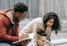 Dreams and Aspirations: Inspiring Stories of Pursuing Passion cheerful diverse students sharing laptop while studying on street stairs