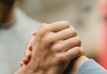 Community Connections: Heartwarming Stories crop sportive couple clasping hands in gym