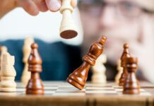 Overcoming Procrastination: Strategies to Kickstart Your Motivation man holding chess piece