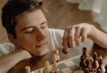 Staying Resilient in Your Career: Strategies for Overcoming Setbacks and Challenges woman holding brown wooden chess piece