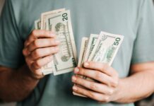Negotiating Your Salary: Techniques for Securing the Compensation You Deserve crop man counting dollar banknotes