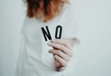 Saying No: Learning to Prioritize and Decline Non-Essential Tasks person holding letters