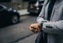 Time Management Hacks: Maximizing Efficiency in Your Daily Routine faceless african american entrepreneur looking at wristwatch