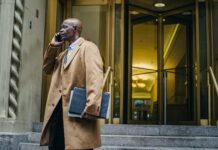 Mastering the Art of Networking: Building Connections for Career Success black businessman speaking on smartphone near building