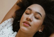 Mindfulness for Sleep: Techniques for Improving Sleep Quality and Quantity peaceful young black woman relaxing with closed eyes