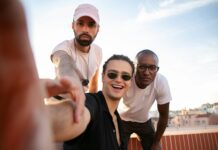 The Power of Positive Self-Talk: Building Confidence and Self-Esteem joyful trendy young diverse guys taking self portrait on roof