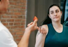 Creating Healthy Boundaries: Nurturing Self-Respect and Relationships personal trainer offering strawberry to a young woman