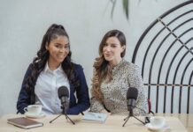 Career Triumphs: Real-Life Tales of Climbing the Corporate Ladder content young diverse businesswomen sitting at table with microphones during meeting