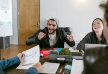Motivation Boosters: Tips for Maintaining Momentum woman in black jacket sitting beside woman in gray sweater