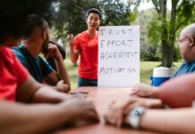 Leadership Legends: Profiles of Influential Leaders and Their Journeys to Success man in red shirt speaking to the group