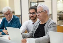 Building a Personal Brand: Showcasing Your Unique Skills and Qualities a man teaching elderly people about modern technology