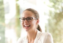 PERSONAL DEVELOPMENT laughing businesswoman working in office with laptop