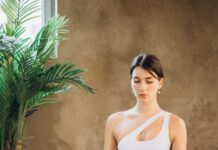MINDFULNESS AND WELLNESS woman meditating in lotus pose