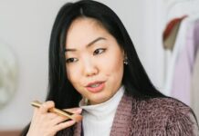 Goal Setting vlogger applying makeup and live streaming with her phone