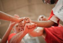 Is Motivation a Skill? basketball team stacking hands together