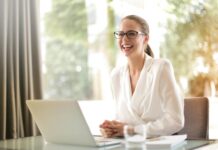 Career Development Cycle laughing businesswoman working in office with laptop