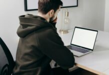 Examples of Productivity in Business man in black jacket sitting in front of macbook pro