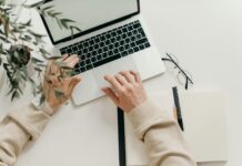 Ways to Increase Productivity in a Business person in beige long sleeve shirt using macbook pro