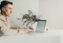 How to Increase Productivity in Life woman in gray sweater using macbook pro