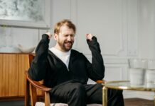 Difference between Motivation and Emotion in Psychology man in black suit sitting on brown wooden chair