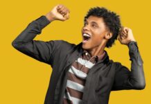 Unbelievable Success Stories delighted black man raising hands in fists in excitement