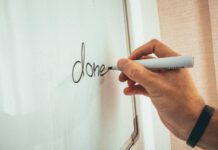 Career Development Training Topics crop man writing on whiteboard in modern office