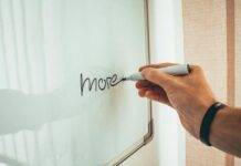 The Importance of Motivation in Management crop male employee writing on whiteboard in office