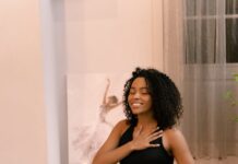 10 Benefits of Mindfulness woman with curly hair doing yoga