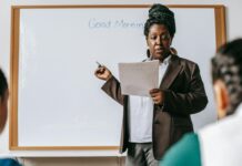List of Professional Development Topics for Teachers focused black female teacher explaining class plan to pupils