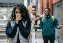 The Greatest Failure in Life as a Student sad ethnic woman crying after being bullied by multiracial male students