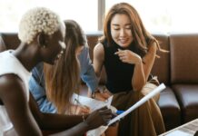 Importance of Career Development in HRM multiethnic cheerful colleagues talking about job and working with documents