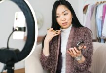 Productivity Tips for Entrepreneurs vlogger applying makeup and live streaming with her phone