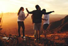 What is Motivated Life? four person standing at top of grassy mountain