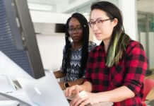 Key Elements of Personal Development woman wearing red and black checkered blouse using macbook