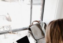 How to Start a Productive Day? close up photography of woman sitting beside table while using macbook