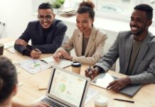 What are the 7 Aspects of Personal Development? photo of three people smiling while having a meeting