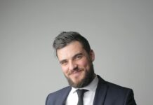 How is a Successful Person? man in black suit holding a calling card