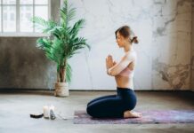 What is Mindfulness in Wellness? woman meditating with candles and incense