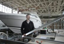 How to Improve Productivity serious adult worker examining metal part near boat in workshop
