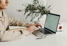 What is True Success in Life? person in brown long sleeve shirt using black laptop computer