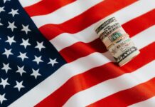 What is Bill Gates success story? american flag with rolled dollar bills