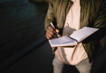 How to Plan Your Day? unrecognizable man writing notes in notebook