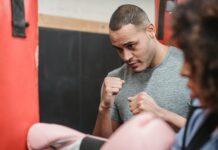 What are the Personal Skills? serious ethnic coach teaching hit technique to woman