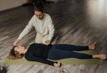 How Does Mindfulness Help Wellbeing? energy practitioner healing relaxed woman on yoga mat