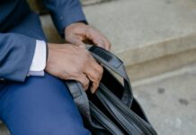 What Are the 5 Steps of Career Development? crop ethnic businessman with leather handbag sitting on steps