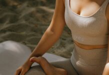 What are the Basics of Mindfulness? a woman in activewear sitting on a yoga mat